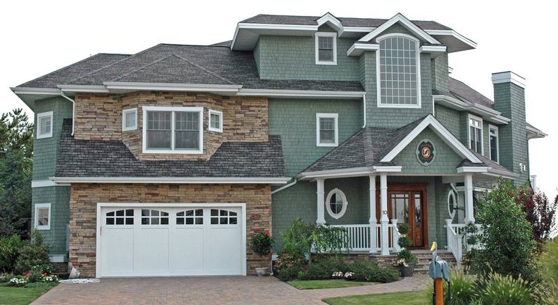 Local two-story home with a multi-gable architectural asphalt shingle roof
